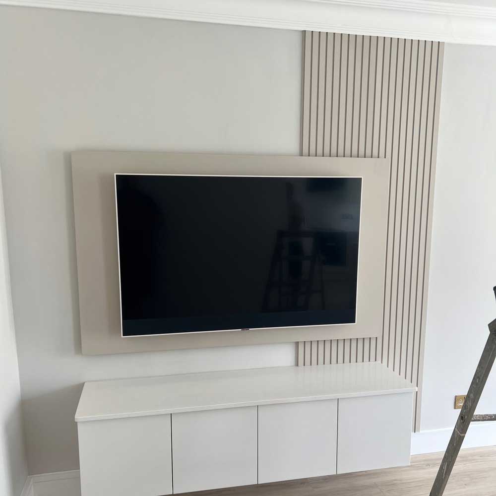 mdf slat wall panelling painted cream behind a tv unit