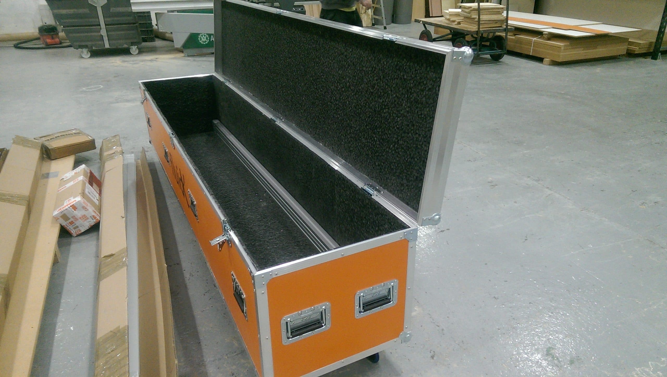 An orange laminated custom built flight case made from plywood with foam lining