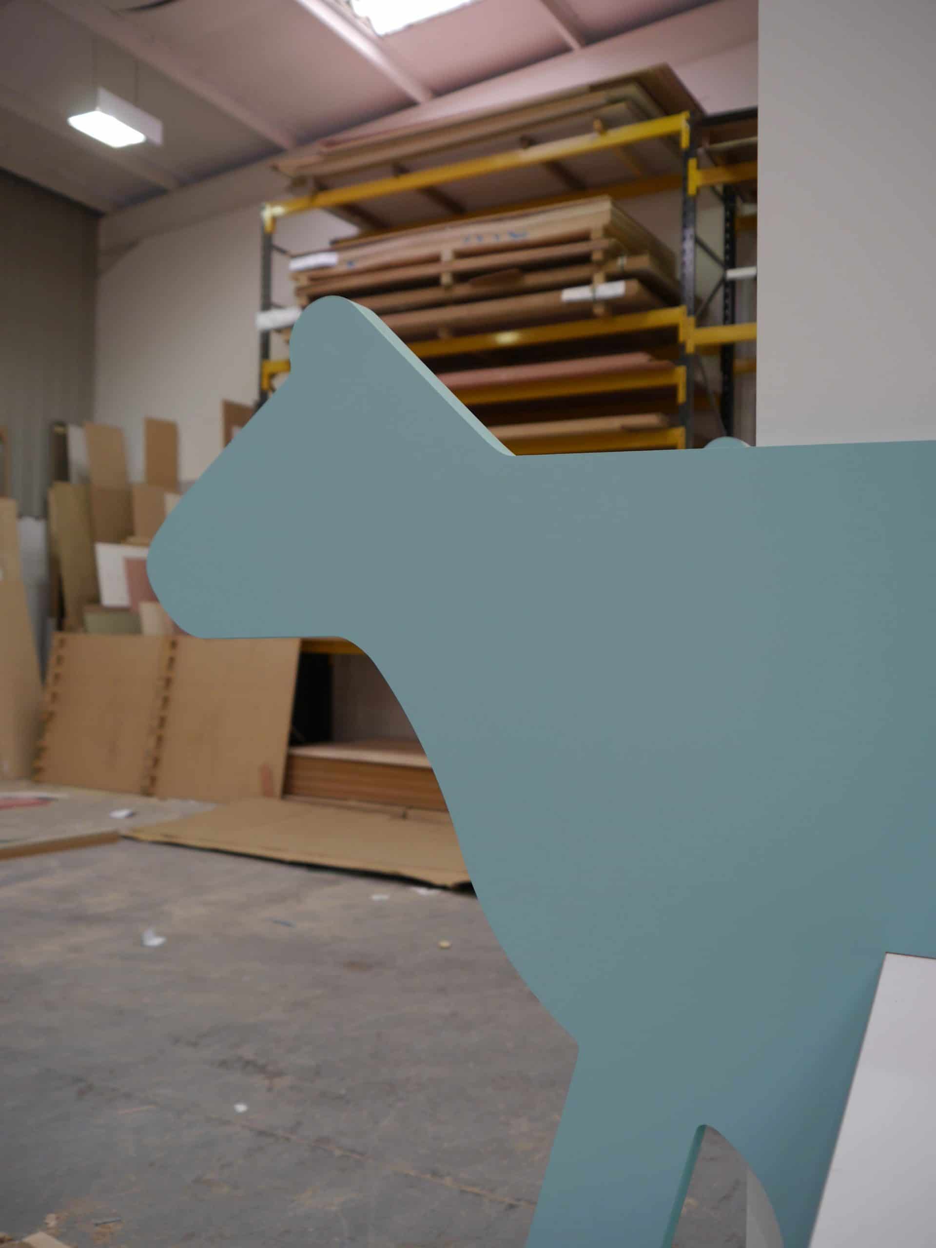 CNC MDF cut to shape of a cow and painted blue