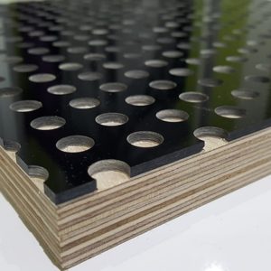 A close up showing perforated black acrylic bonded to a birch plywood panel