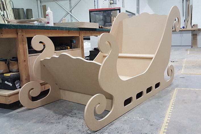 A Christmas wedding photo booth made from MDF in the shape of santas sleigh the sleigh is yet to be painted