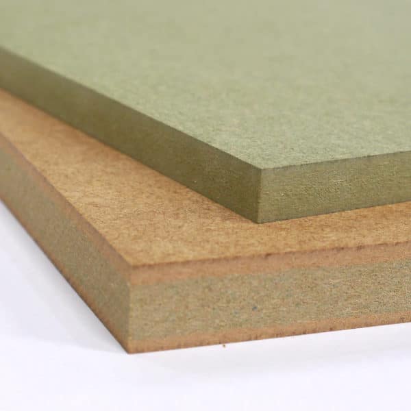Two small pieces of Moisture Resistant MDF stacked on top of each other, one is 12mm MR MDF the other 18mm. Both show the green dye used to distinguish it from other MDF products