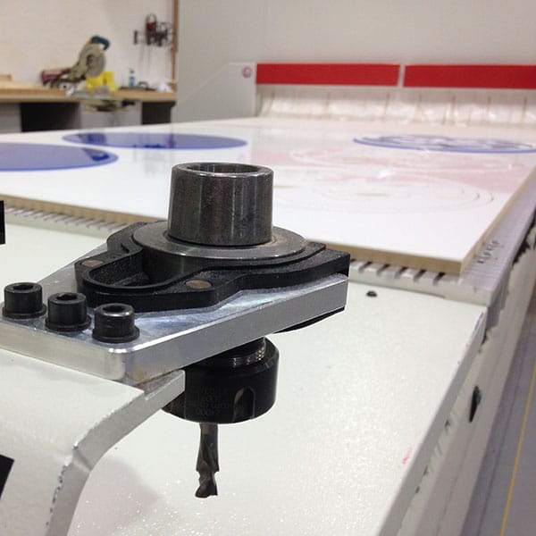 close up of cnc router machine with white board laid down as a material to cut