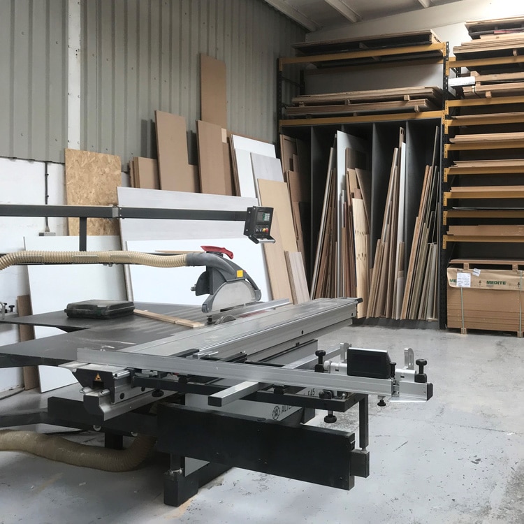 An Altendorf F45 panel dimensioning saw sitting in front of an off cut rack in a workshop