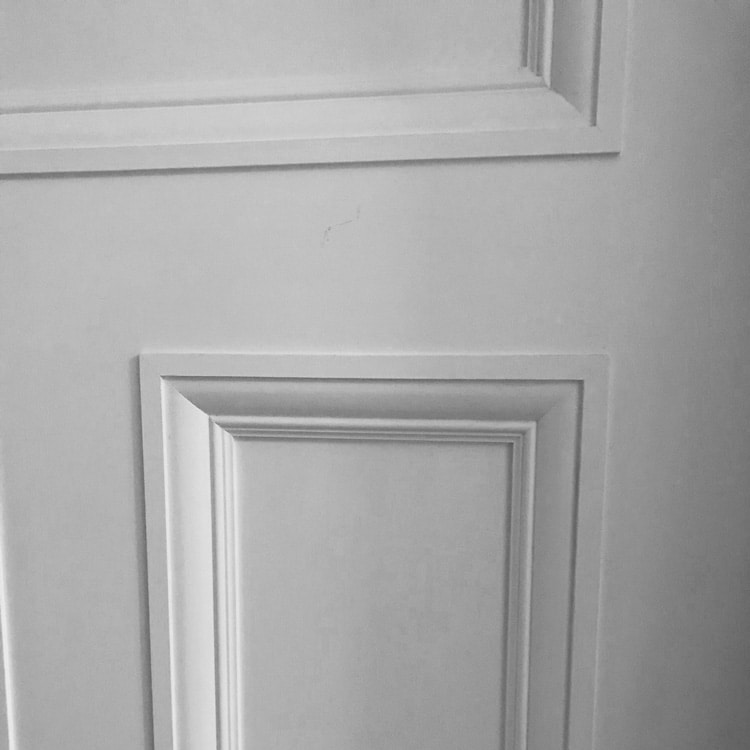 A close up photo showing a white painted reproduction Victoriandoor