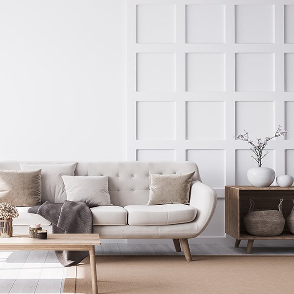 A lounge area with white shaker style wall panelling