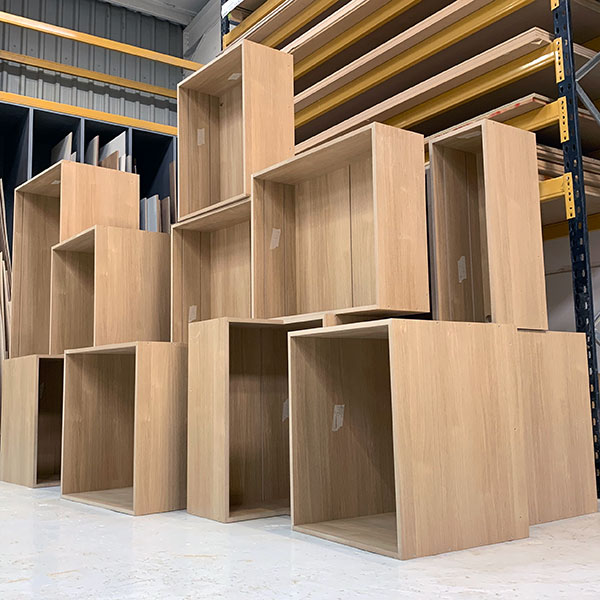 A stack of Oak melamine faced MDF kitchen carcasses ready to be despatched to a bespoke kitchen company