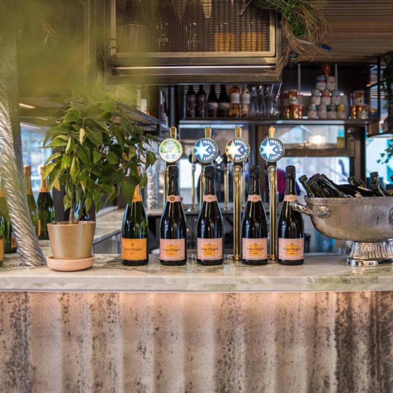 large fluted panelling used on a bar with champagne on top of it