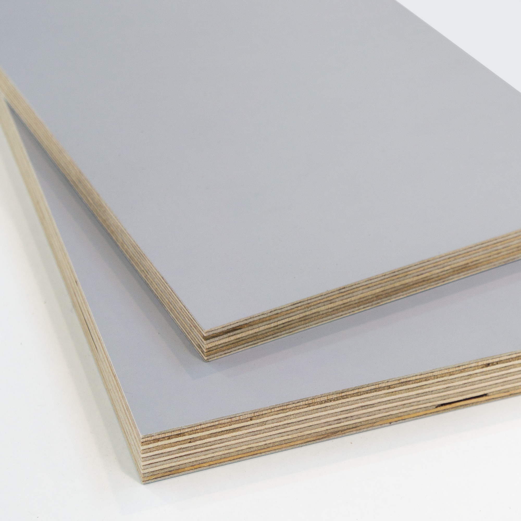 two pieces of grey melamine faced plywood on a white background