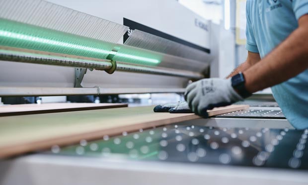 veneered being cut to size on a beam saw machine
