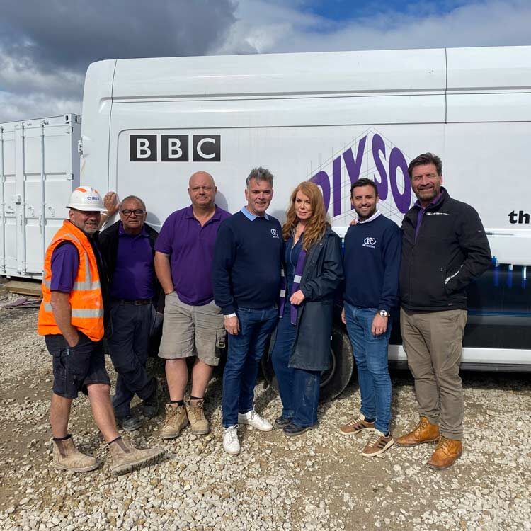 group of people standing infront of BBC DIY SOS van