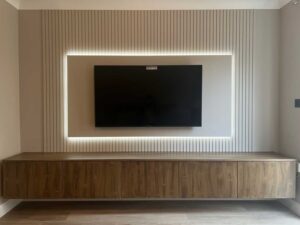 paintable slat wall panels situated behind a tv media wall