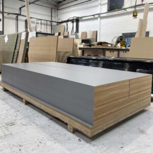 finsa gris tormenta panels cut in hald and edged on long side in a workshop