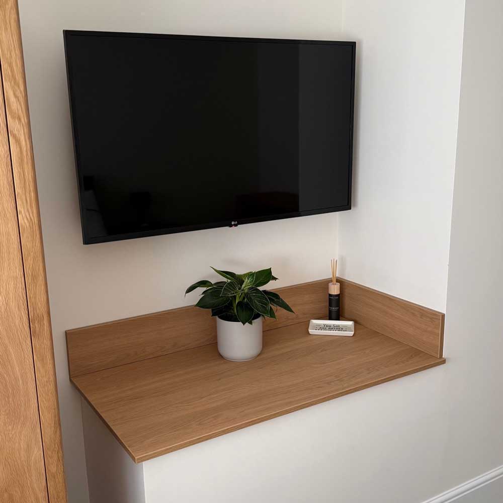 Finsa lissa oak melamine board shelving below a tv in a bedroom