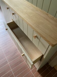 drawer front v groove panels painted in green on a unit