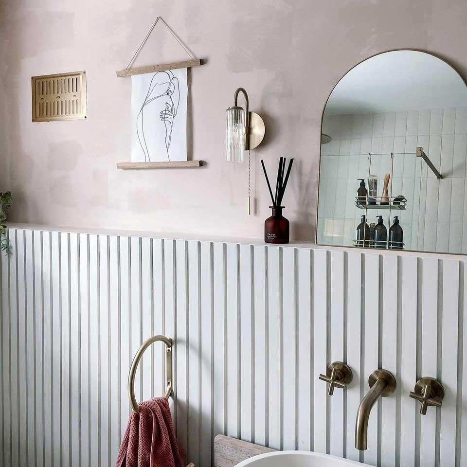 custom slat width paintable mdf slat wall panelling, painted in white in a bathroom behind a sink unit