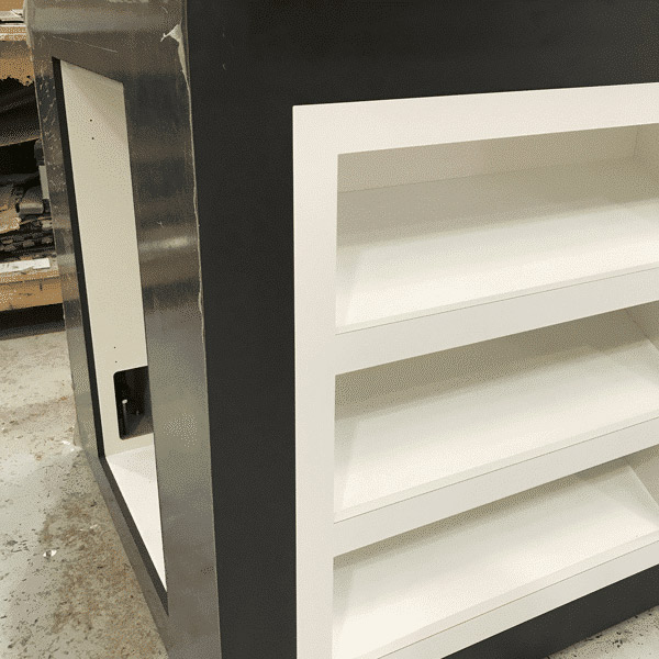 A black and white display product plinth finished in black laminate with a white laminate inlay