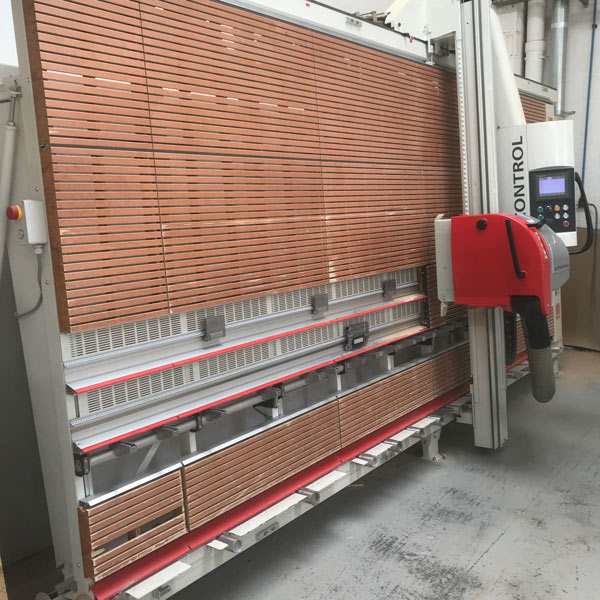 A semi automated Striebig wall saw for cutting and processing wood sheets