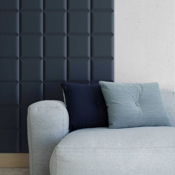 square padded mdf wall panels painted in navy blue behind a sofa